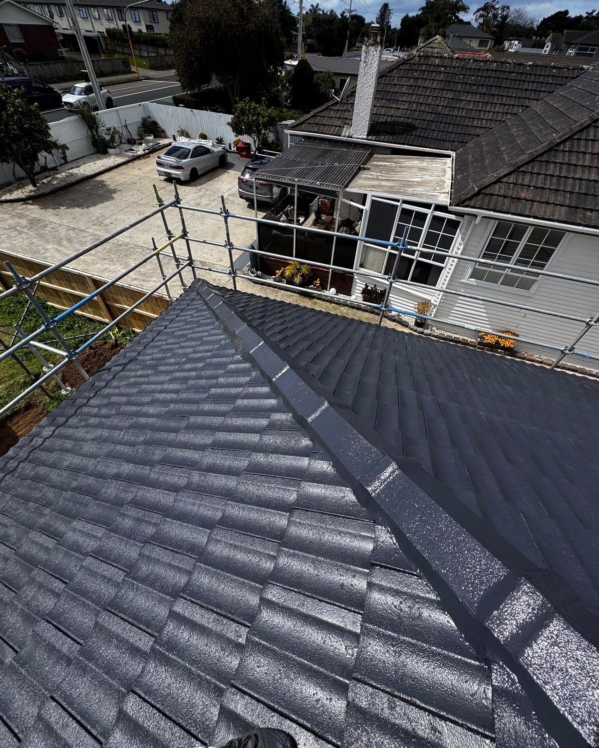Concrete tile roof freshly washed and recoated in charcoal